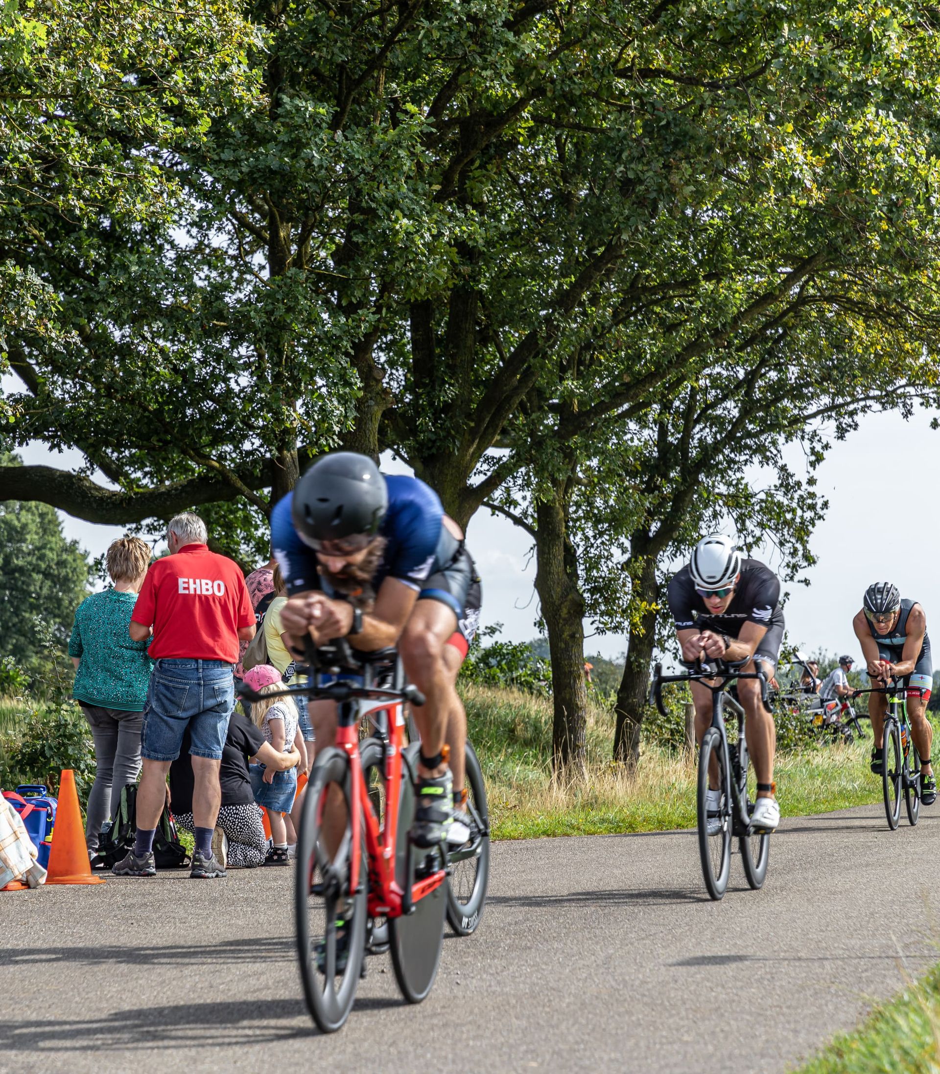 Een groep mensen fietst over een weg.