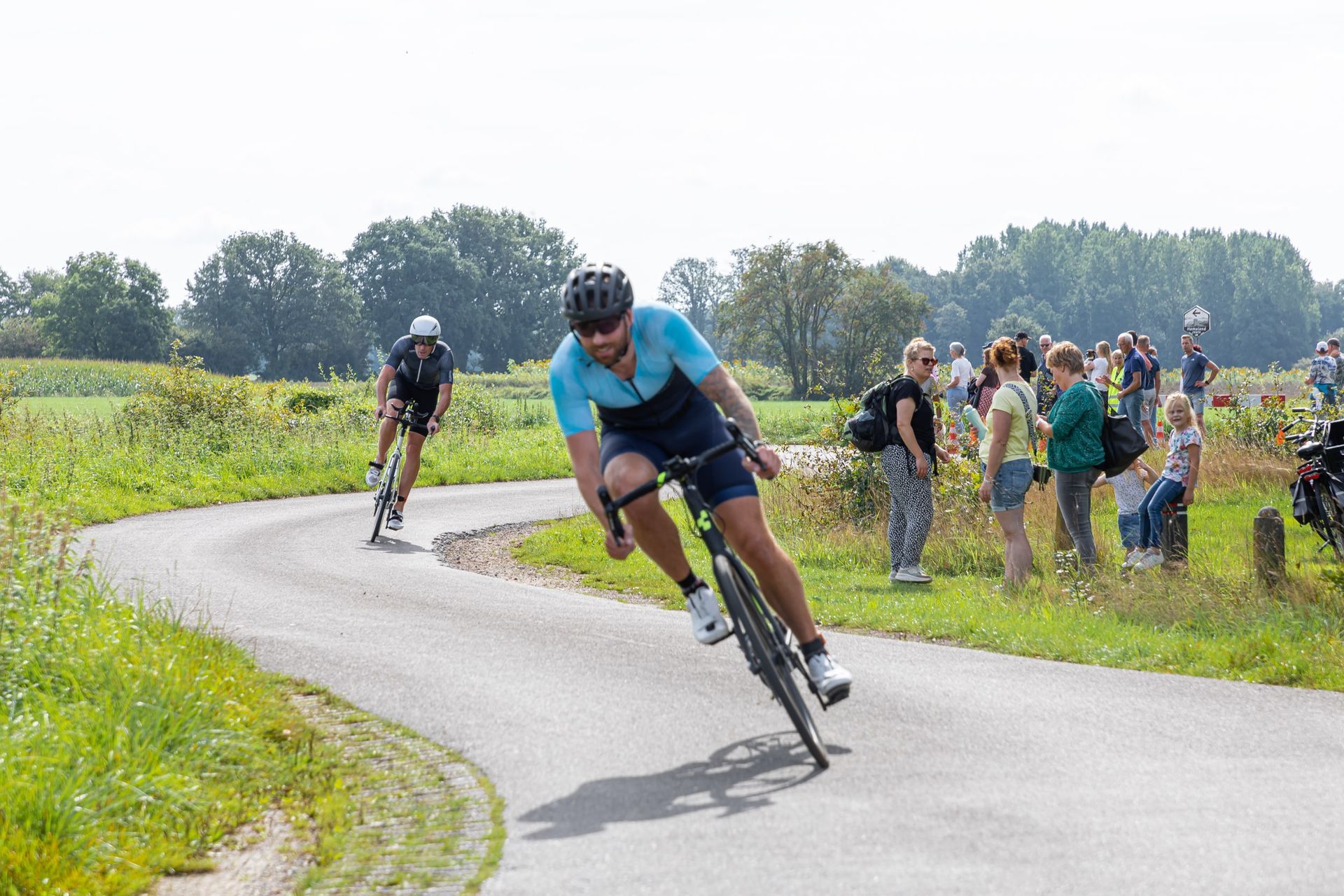 Een man fietst over een bochtige weg.