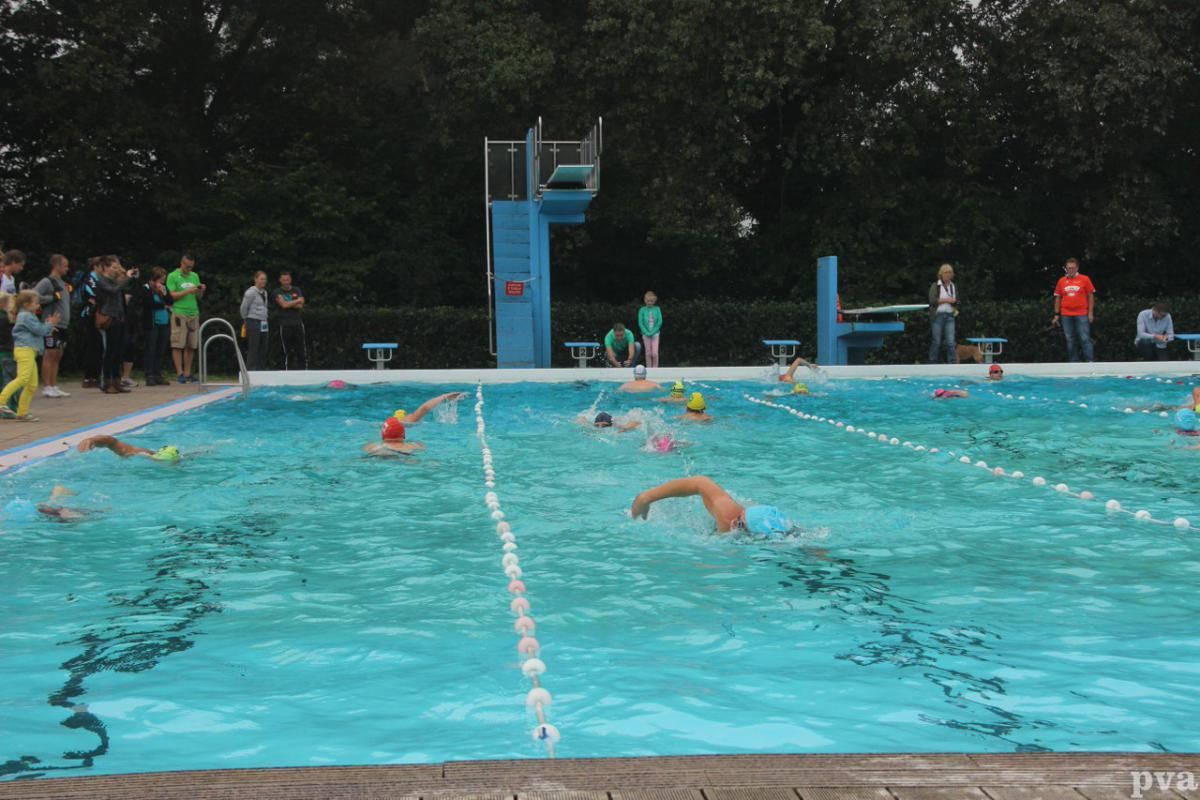 Triathlon Eibergen. Een groep mensen zwemt in een groot zwembad.