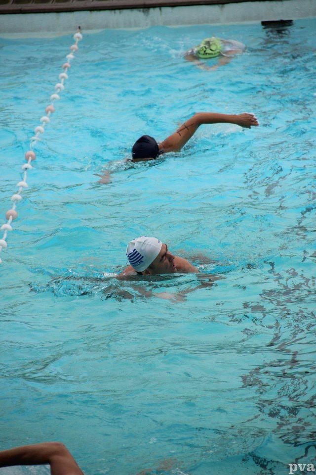Triathlon Eibergen. Een groep mensen zwemt in een zwembad.