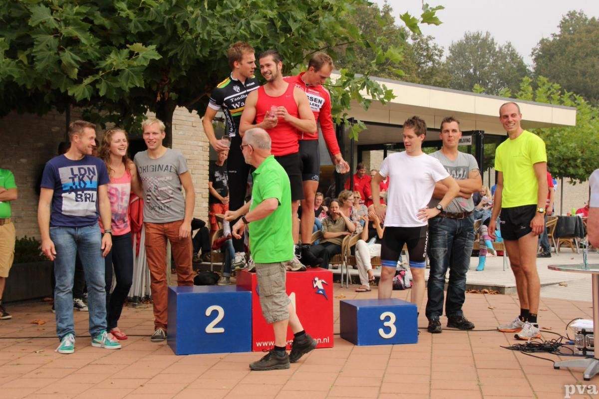 Een groep mensen die op een podium staan ​​met de nummers 2 en 3 erop