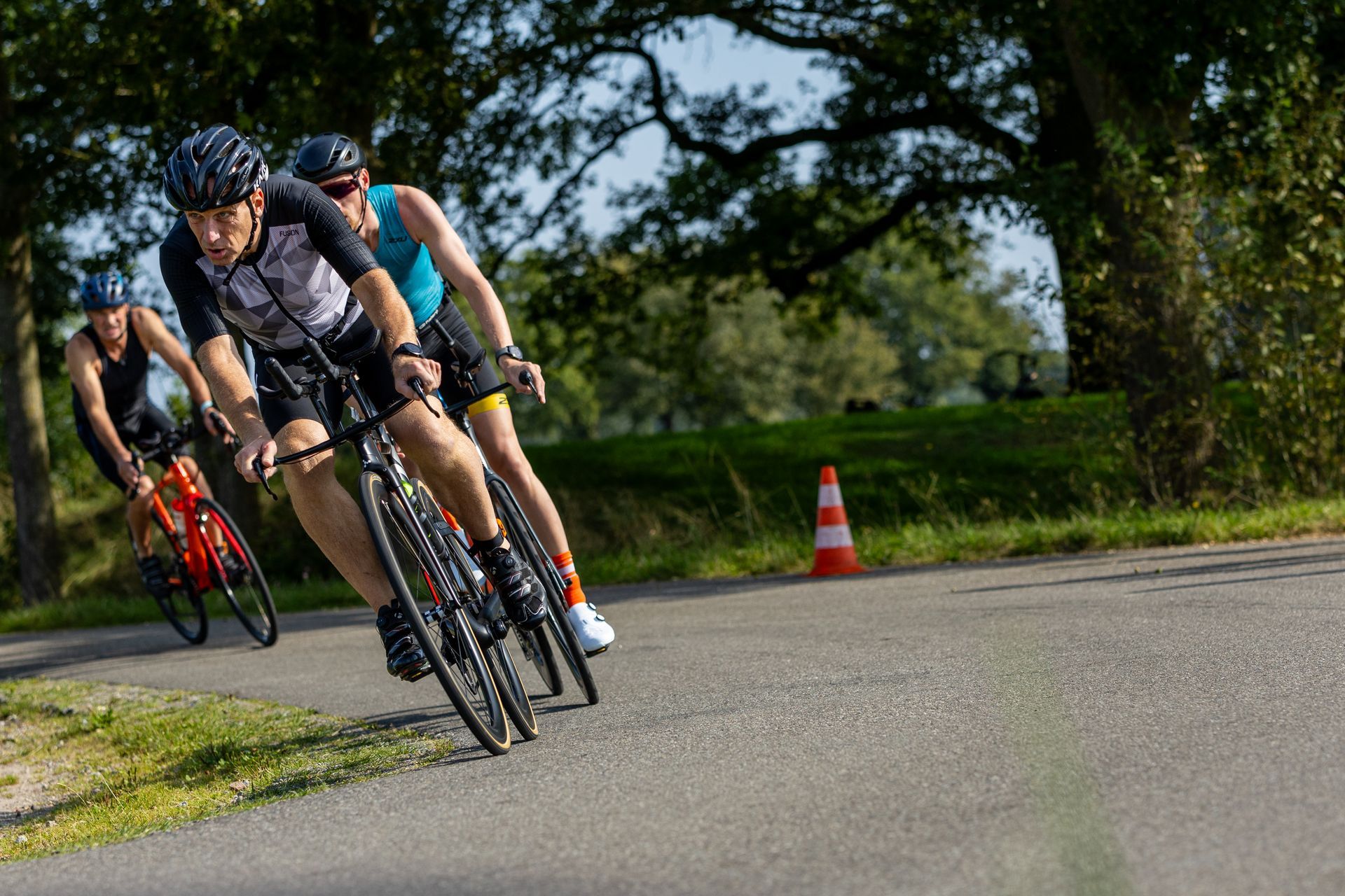 Een groep mensen fietst over een weg.