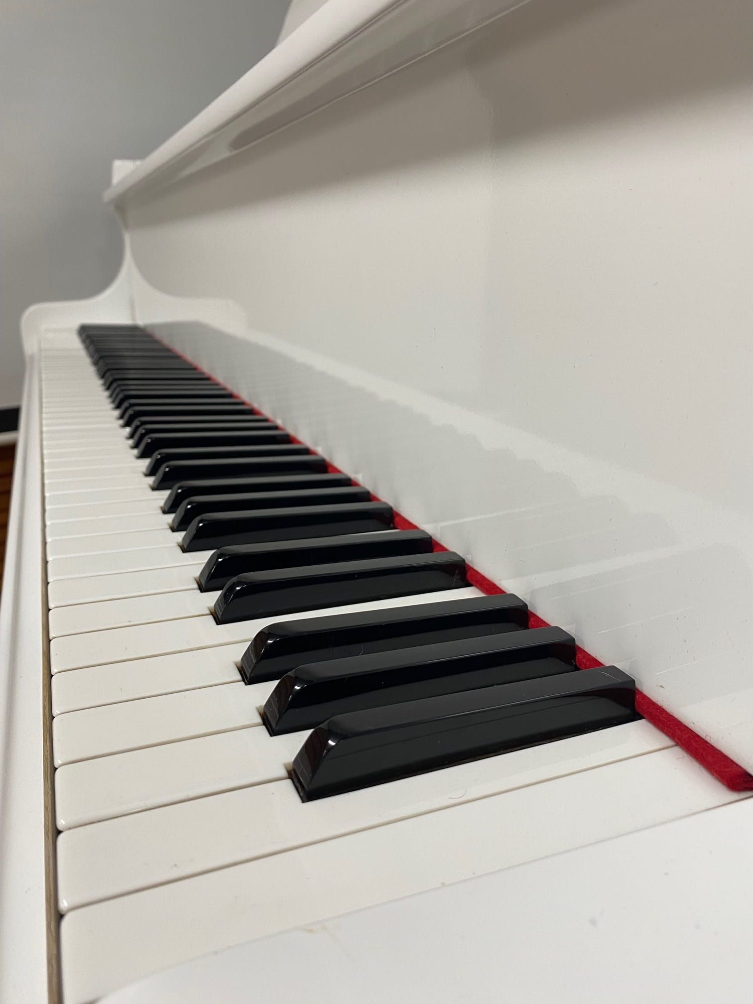 A Close Up Of A White Piano With Black Keys — Doug Simpson Piano Tuning In Manunda, QLD