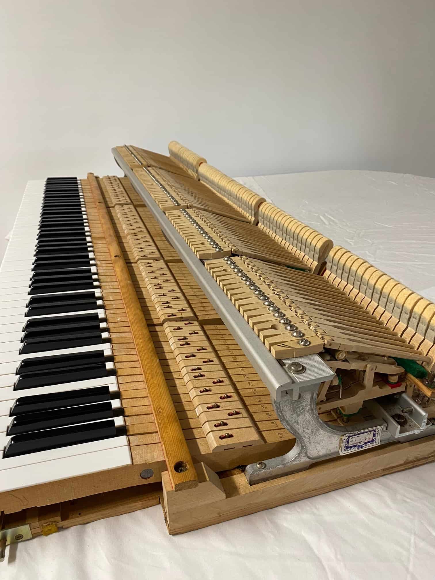 A Piano Keyboard Is Sitting On Top Of A Bed — Doug Simpson Piano Tuning In Manunda, QLD