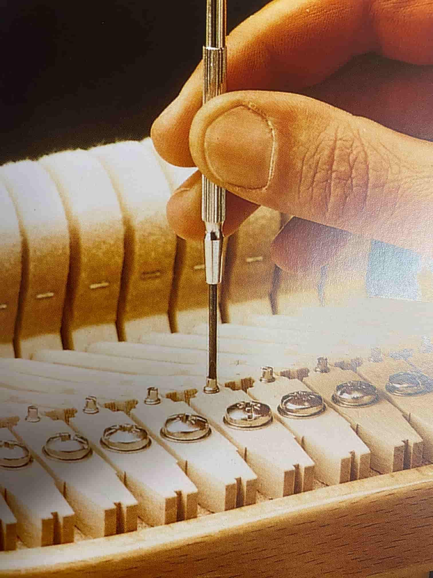 A Person Is Working On A Piano Keyboard With A Screwdriver — Doug Simpson Piano Tuning In Manunda, QLD