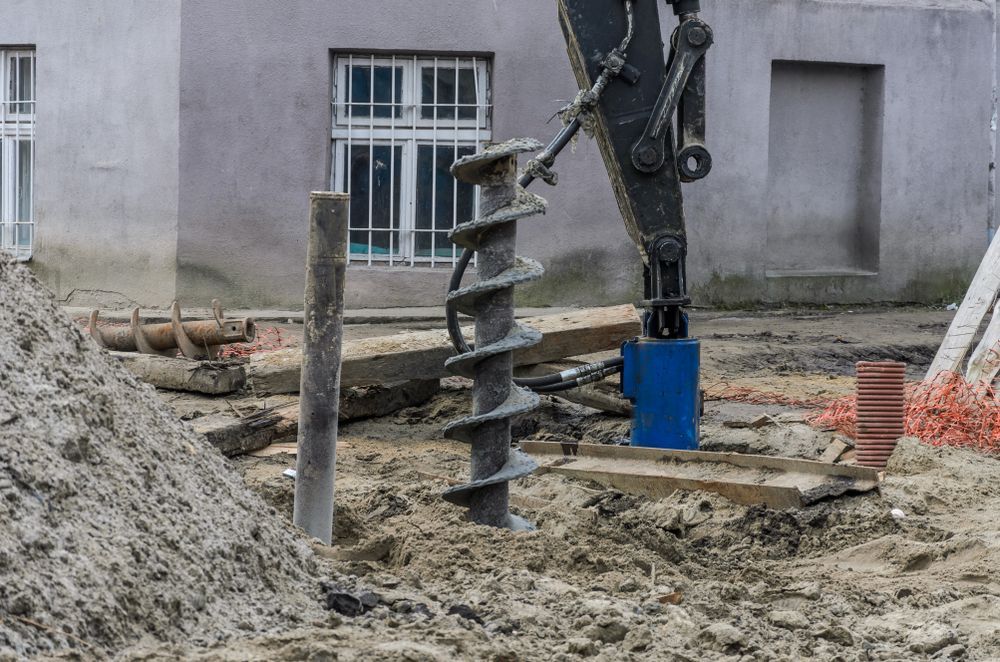 A Drill Is Being Used To Drill A Hole In The Ground At A Construction Site — The Rectifiers In Robina, QLD