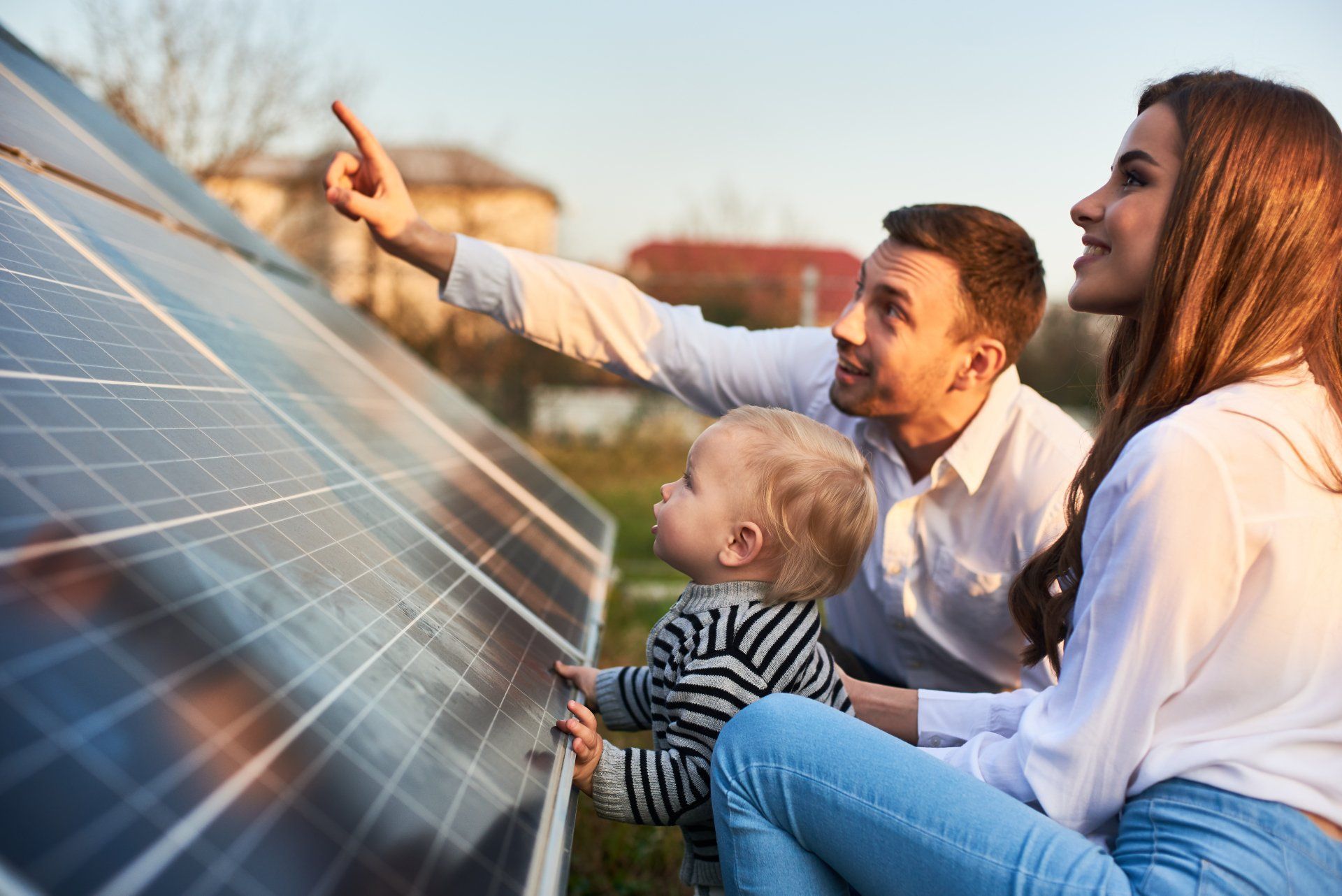 A family is looking at a solar panel.