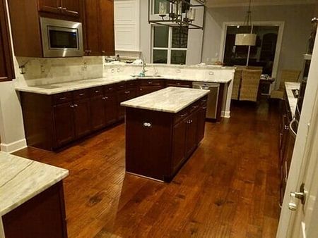Kitchen with marble countertop and hardwood flooring - flooring contractors in Jacksonville, FL