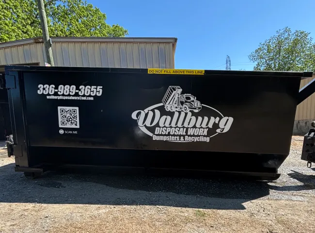A dumpster with a phone number on it