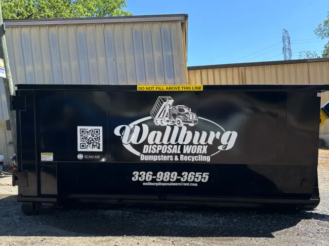 A dumpster with a phone number on it