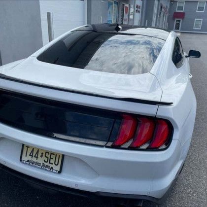 A white car with a license plate that says t44 seu