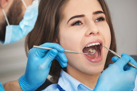 Dentist — Dentist Examining the Teeth of Patient in Saint Peters, MO