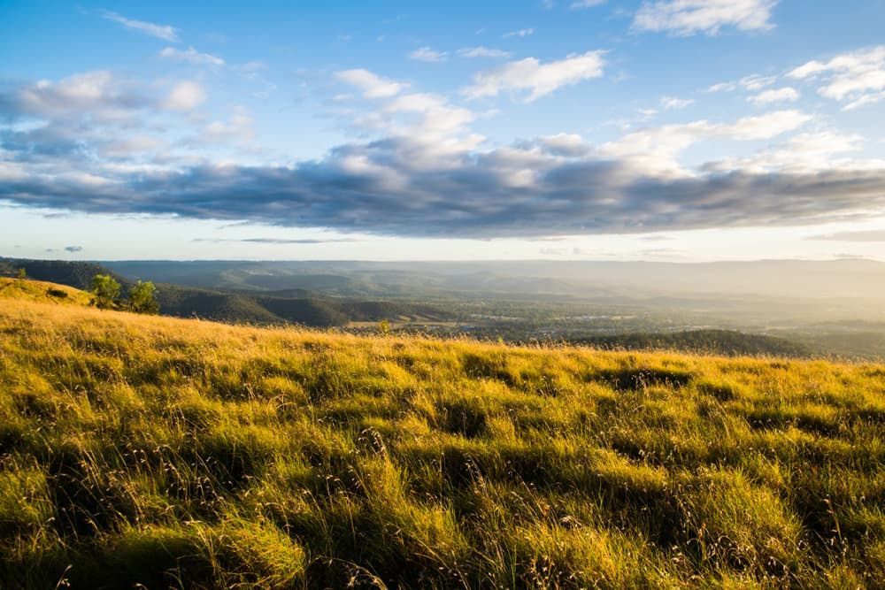 Mountain View with a Big Cloud Above and Yellow Grass Below — Floor Sanding in Toowoomba, QLD