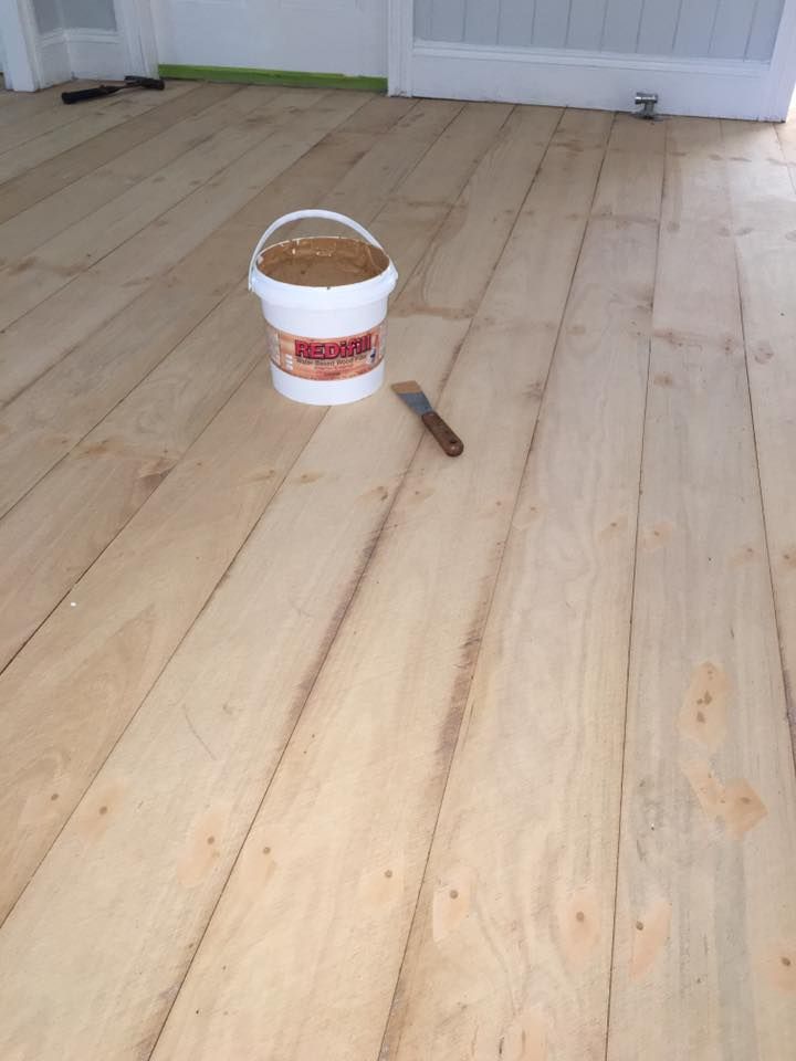 A Bucket of Coat Paint with A Stain Remover in Middle of Floor — Floor Sanding in Kearneys Spring, QLD