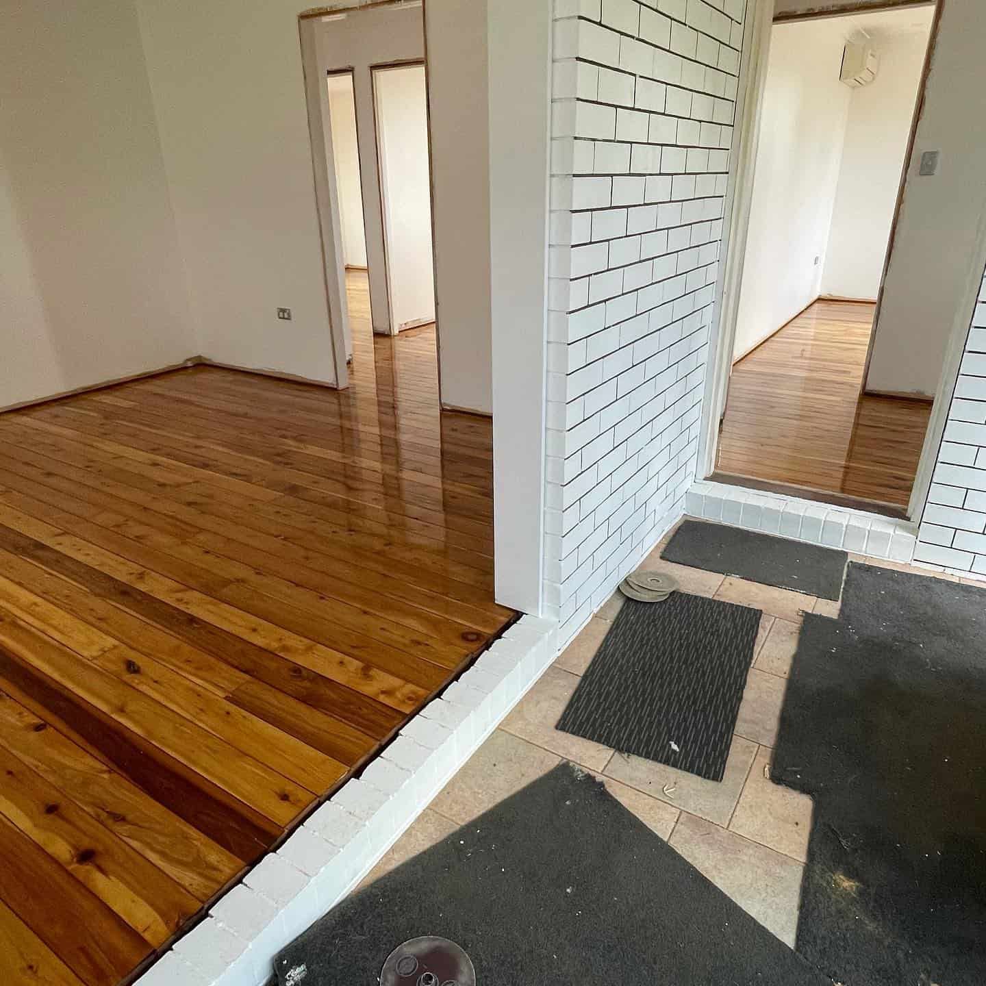 New Room Having Reflective Flooring with White Walls — Floor Sanding in Kearneys Spring, QLD