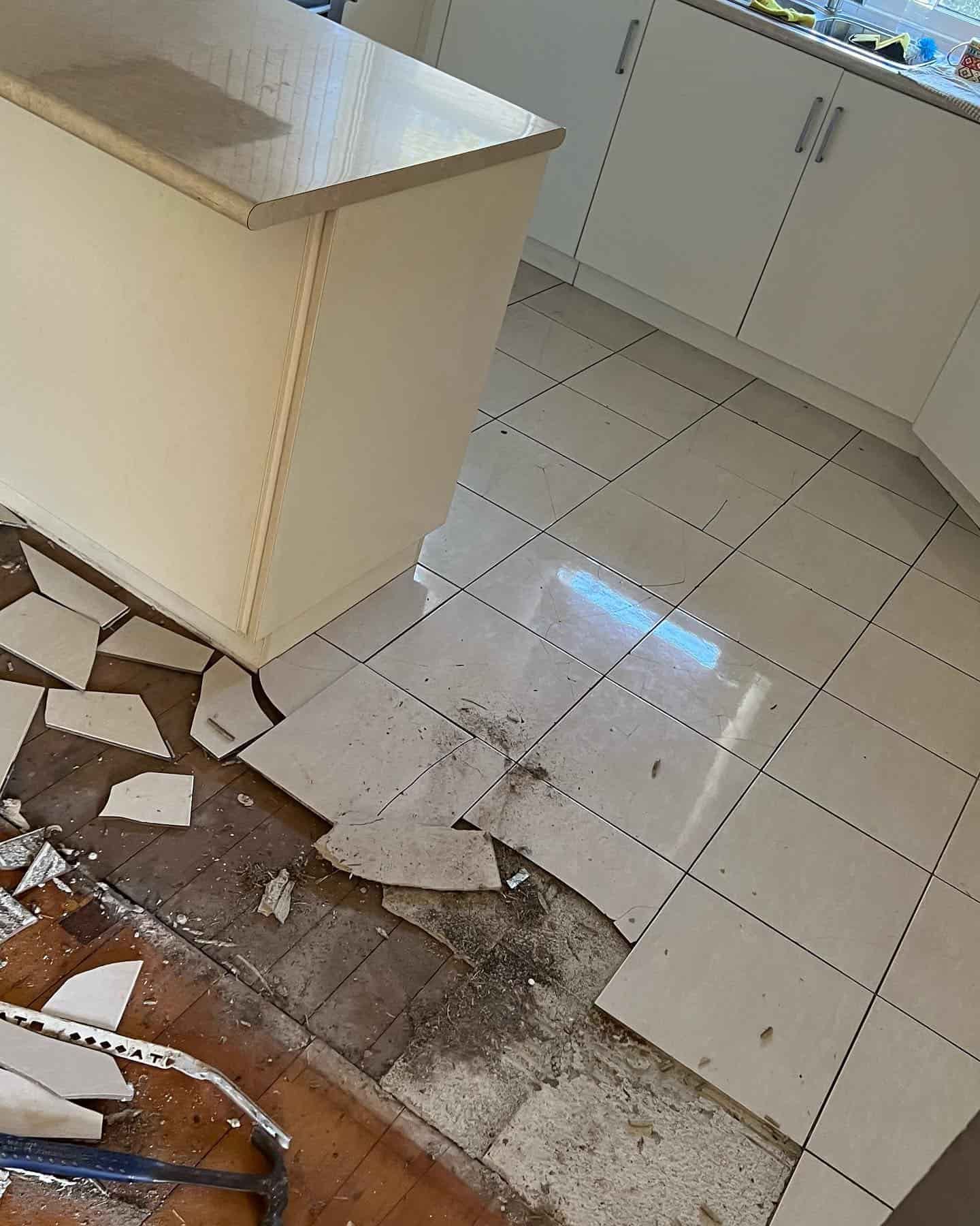 Broken Floor Tiles with White Drawers and Shelves — Floor Sanding in Kearneys Spring, QLD