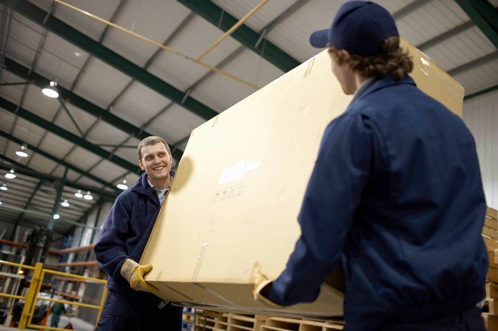 team storing goods in warehouse
