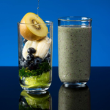 Two tall glasses: one with smoothie ingredients, one with finished smoothie.