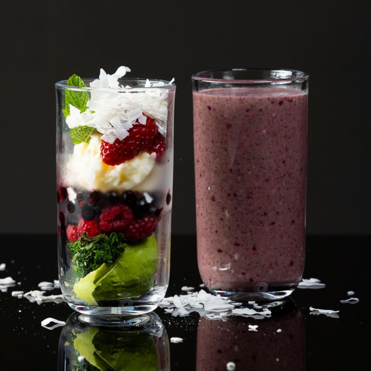 Woman in a pink sweater looking up at the camera, with a pink background.