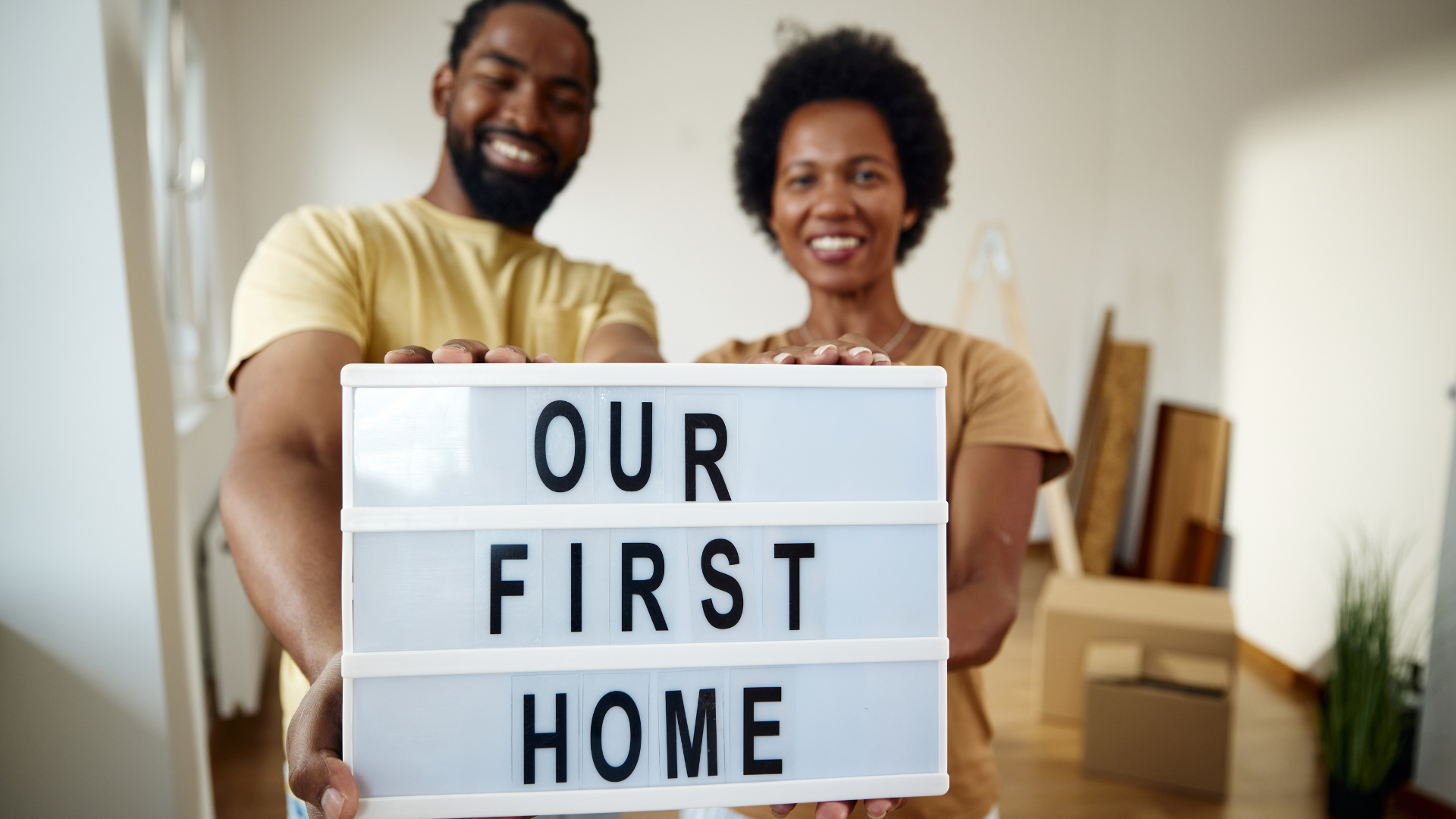 Couple smiling, holding 