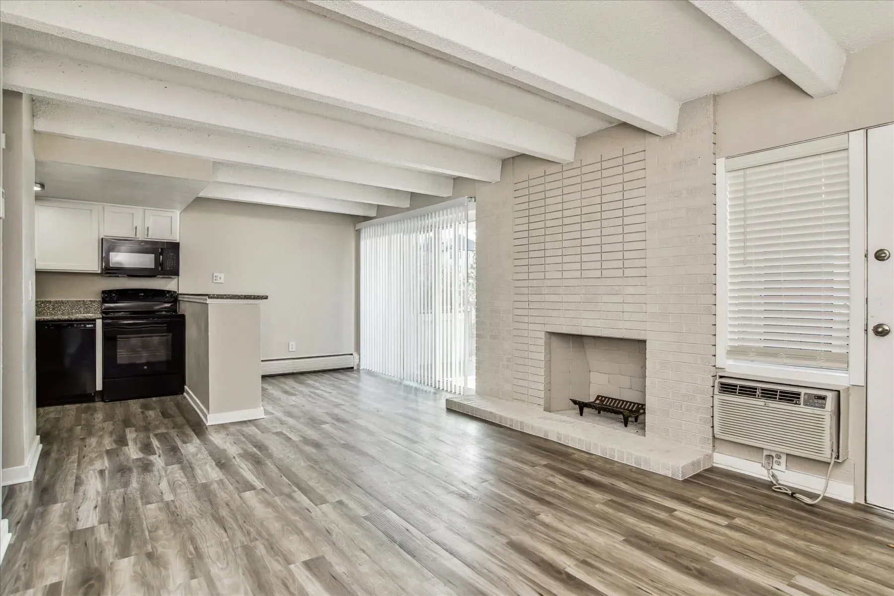 Living room with fireplace and kitchen view