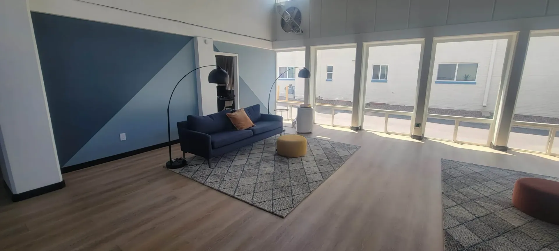 Modern living room with blue sofa and accent chair.