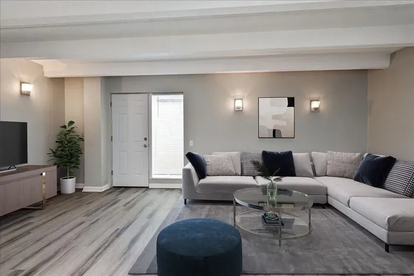 Spacious living room with a large sectional sofa, coffee table, and TV stand.