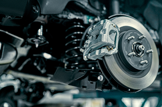 Up close of brakes during vehicle repair | Iberia Discount Tire