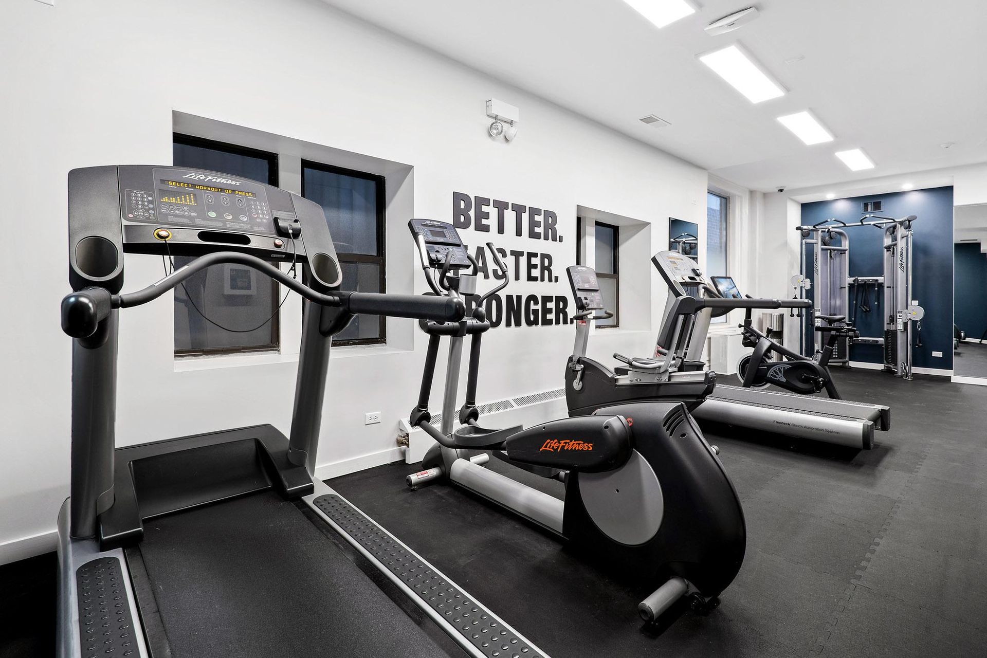 a gym with treadmills and other exercise equipment in a building