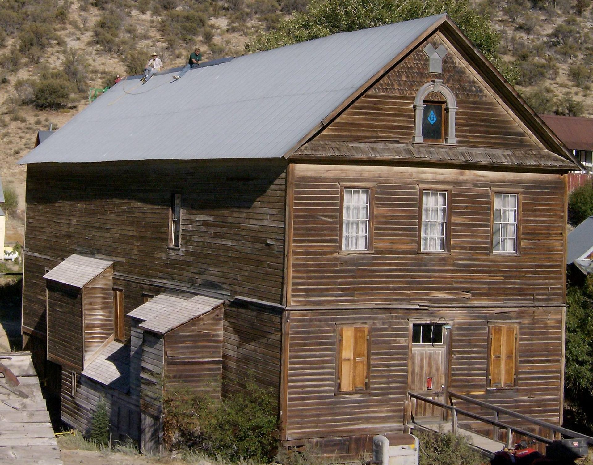 A large wooden house with a gray roof