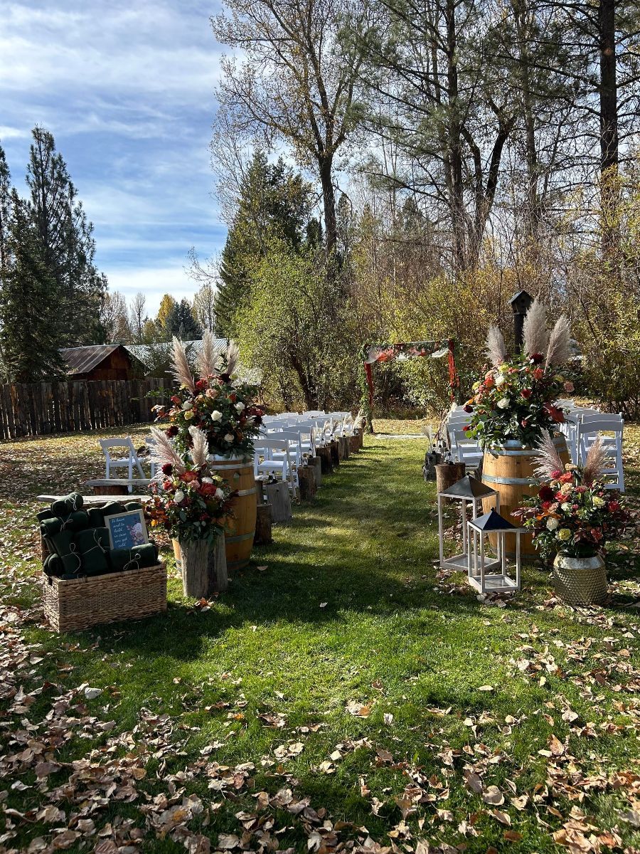 A wedding ceremony is taking place in the middle of a lush green field.