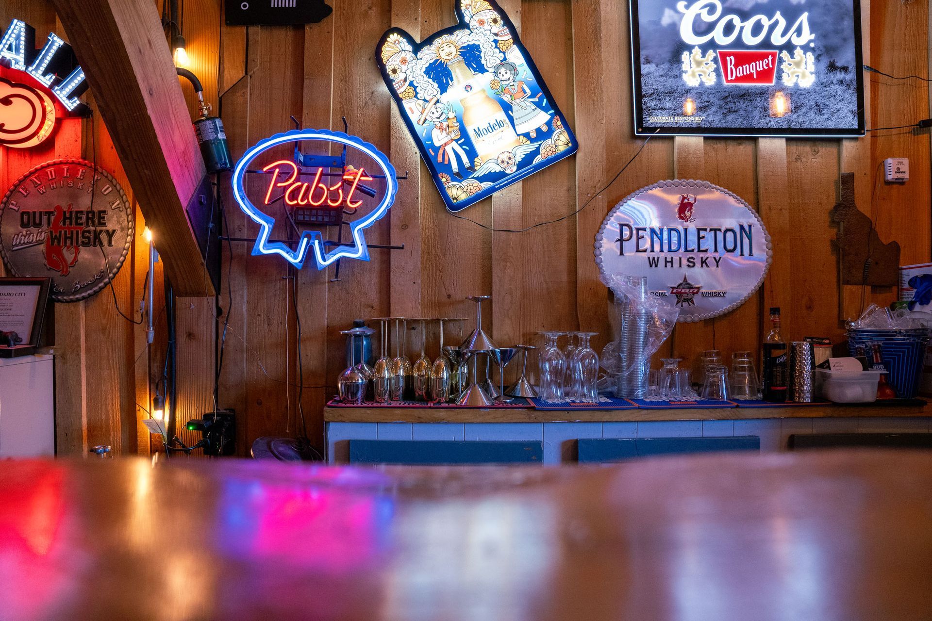 A restaurant with tables and chairs and a bar.