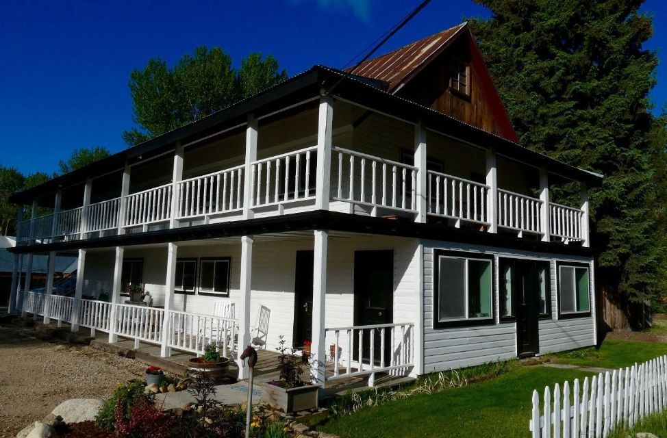 A large white house with a fence in front of it