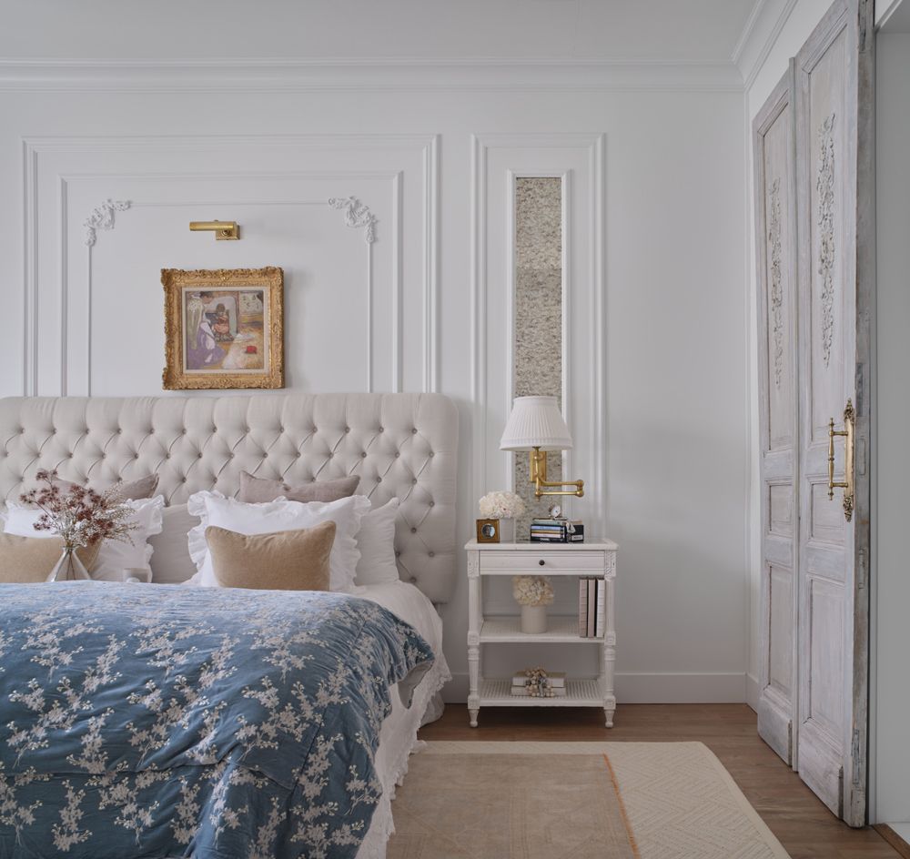 A bedroom with a king size bed and a nightstand