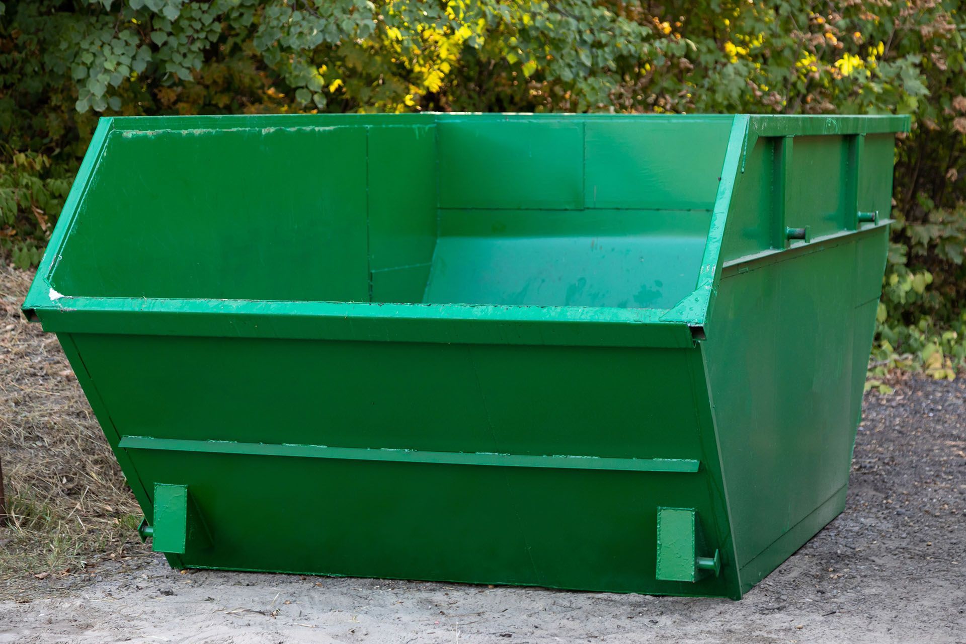 Green dumpster outdoors.