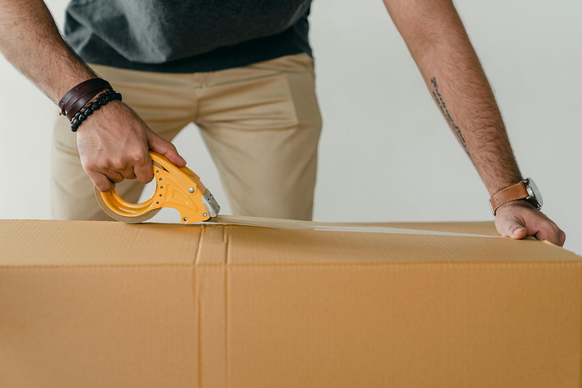 Man taping a box for long-term storage