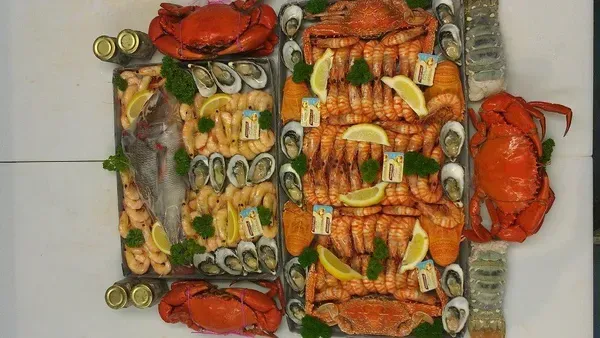 Seafood Platter: Crabs, Shrimp, Oysters, Clams, and Lobster Tails Arranged on A White Surface — Glenmore Seafoods In Park Avenue, QLD