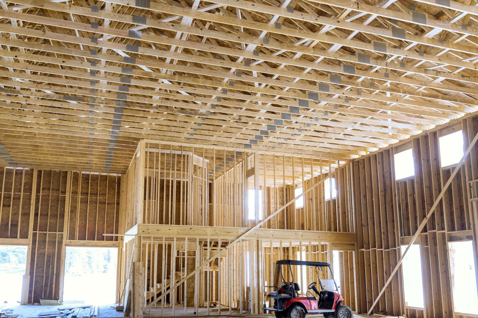 A large house with a garage and a driveway on a rainy day.