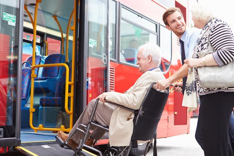 Elderly man in wheelchair getting pushed up a wheelchair ramp elderly man in wheelchair getting pushed up a wheelchair ramp