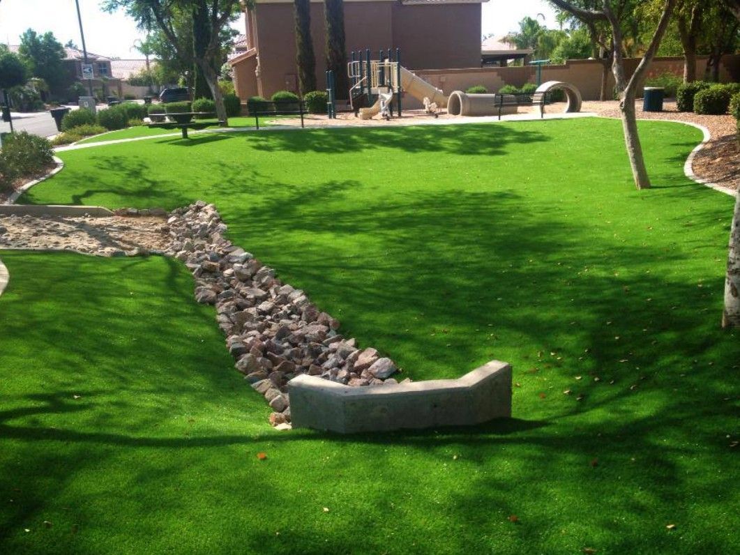 A lawn with a drain in the middle of it