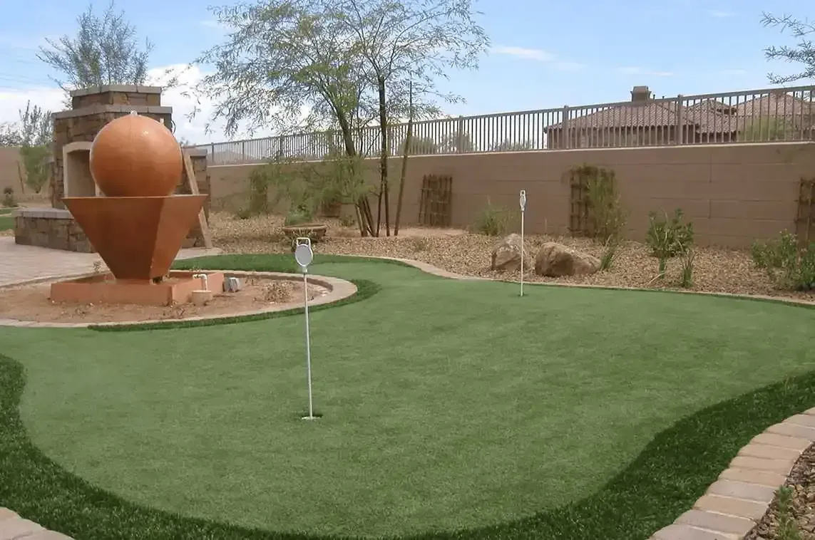A golf course with a fountain in the middle of it.