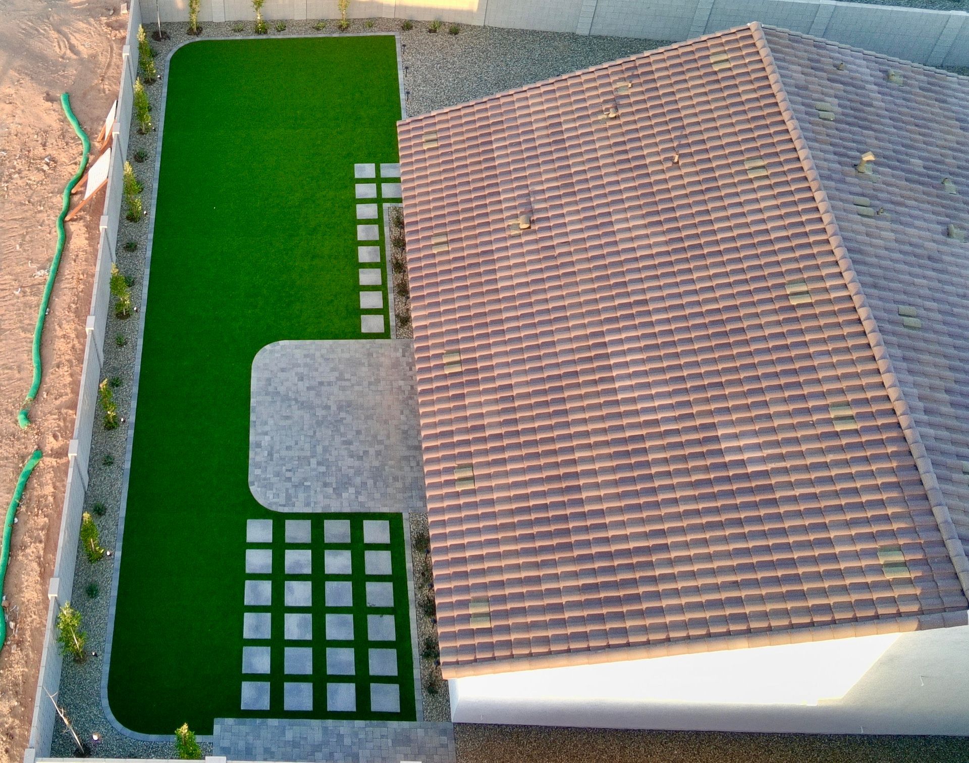 An aerial view of a house with a large lawn in front of it