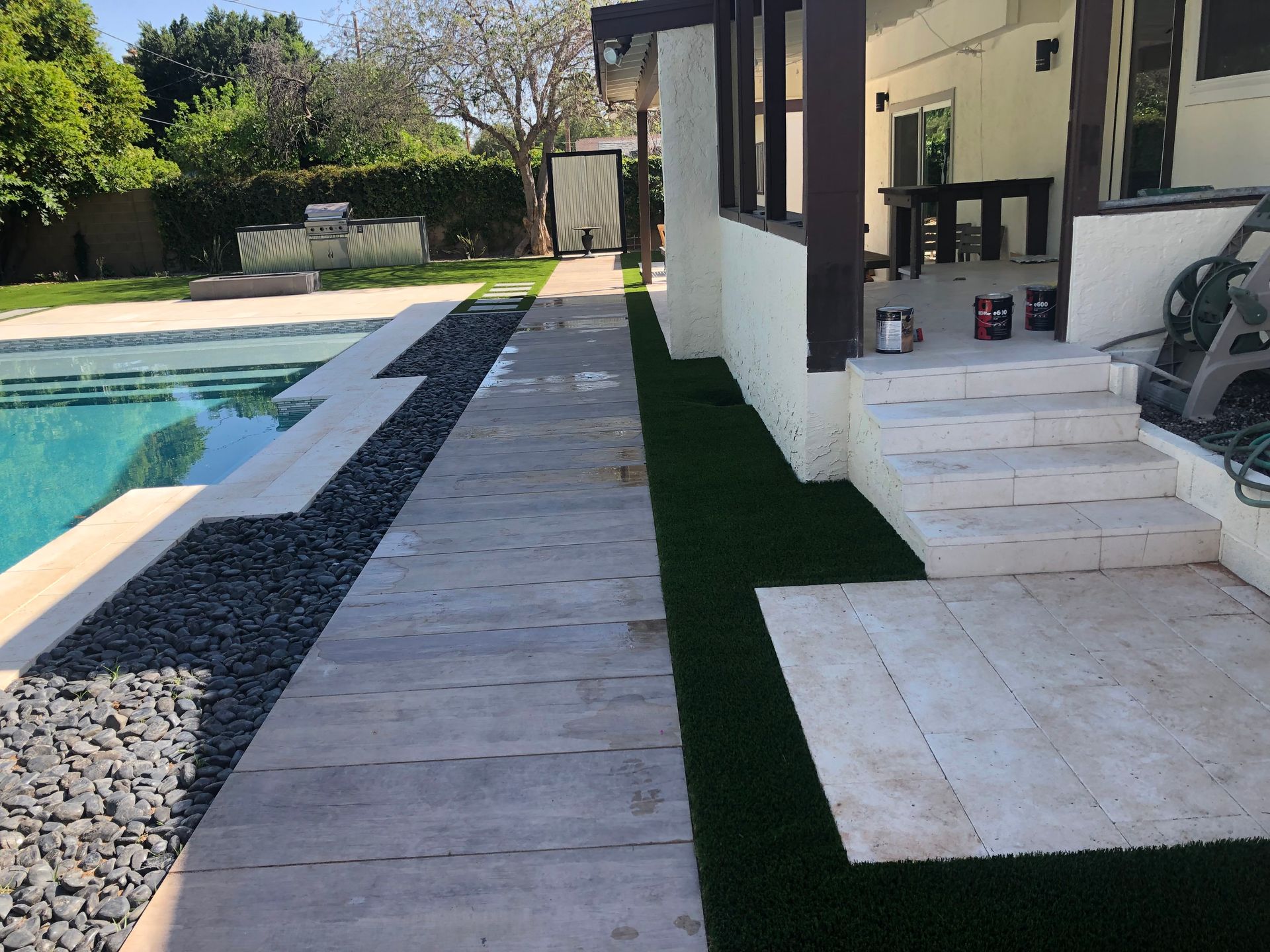 A house with a swimming pool and a walkway leading to it