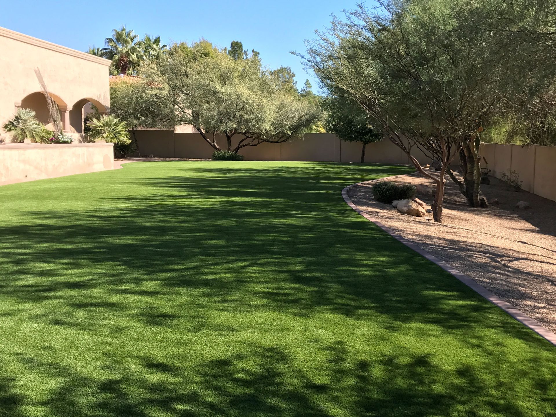 A large lush green lawn in front of a house.