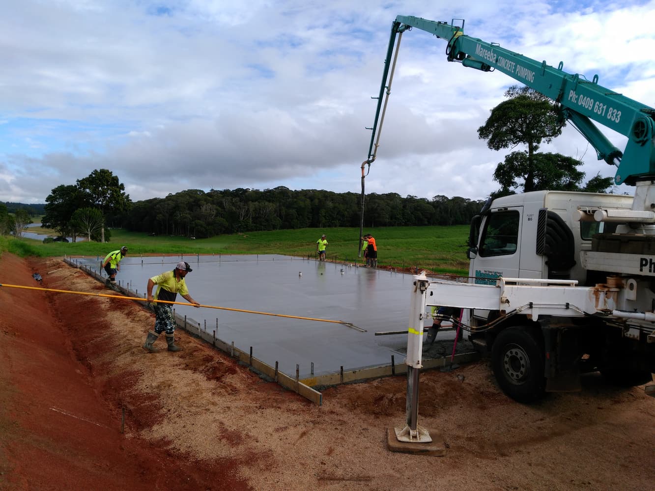 Workers Laying Slab for a Large Shed - Shed Builders in Atherton, QLD