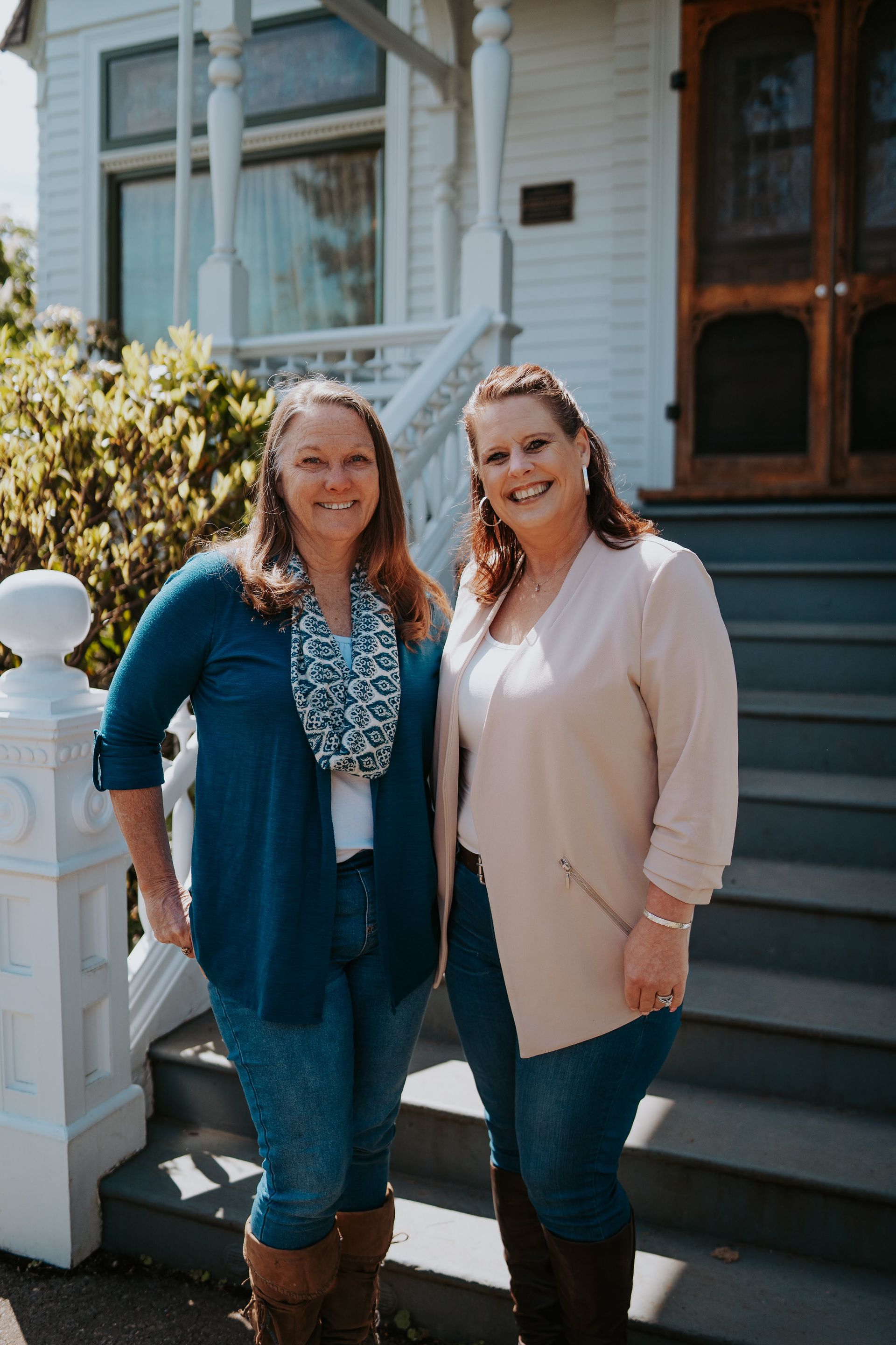 A man and woman are laying on a couch holding a baby.