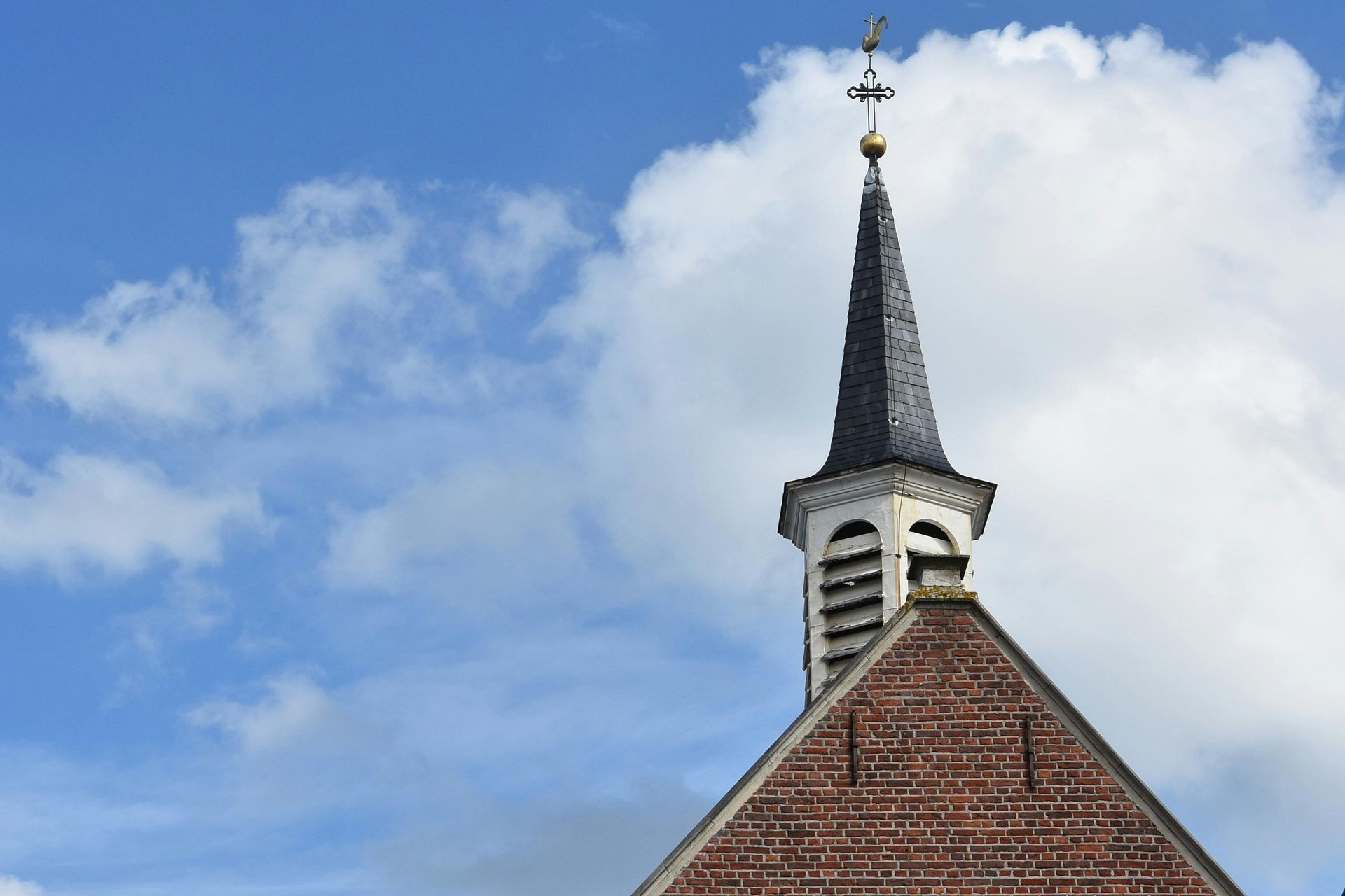 A church steeple with a cross on top of it