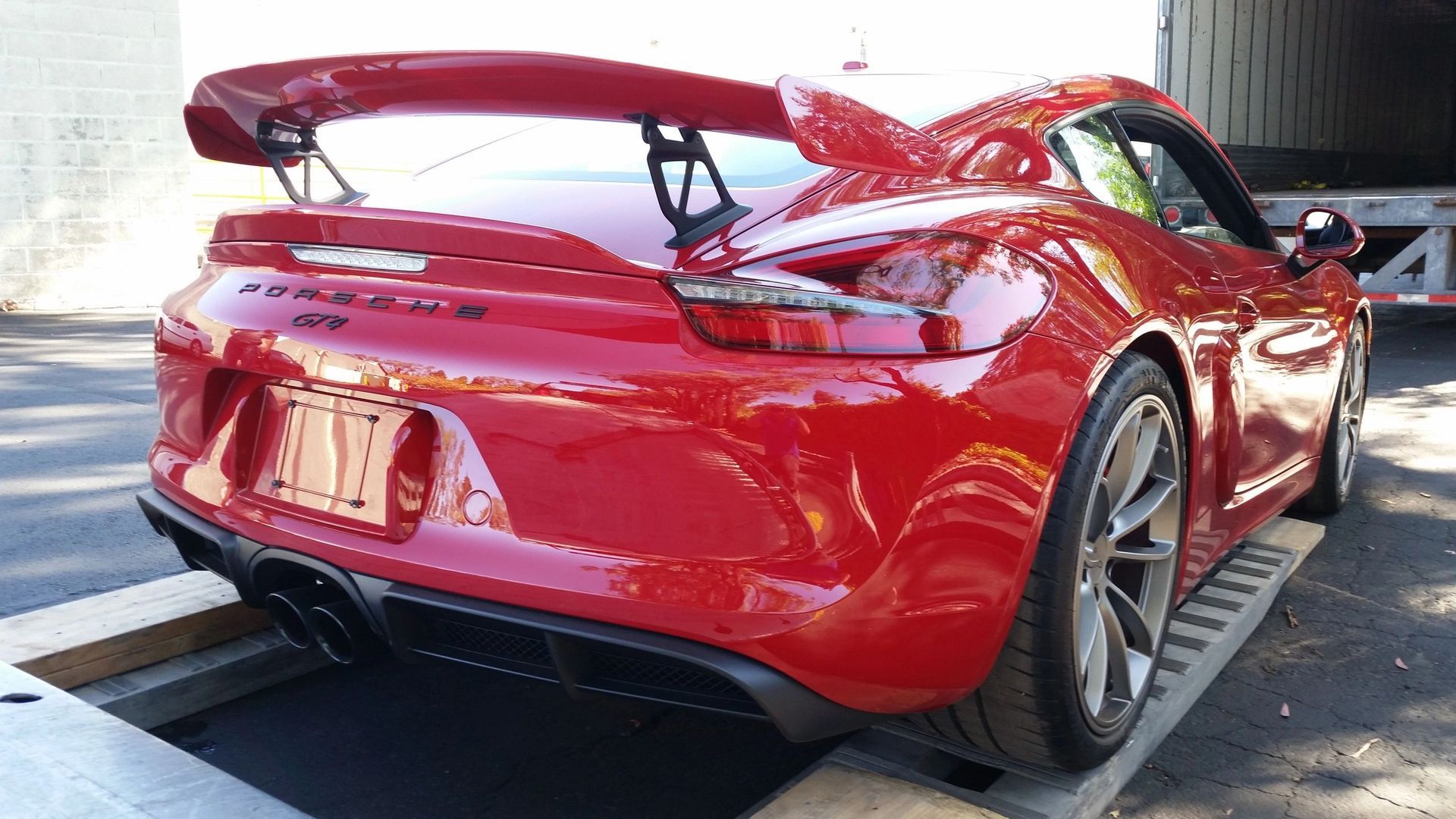 A man is towing a car on a tow truck.