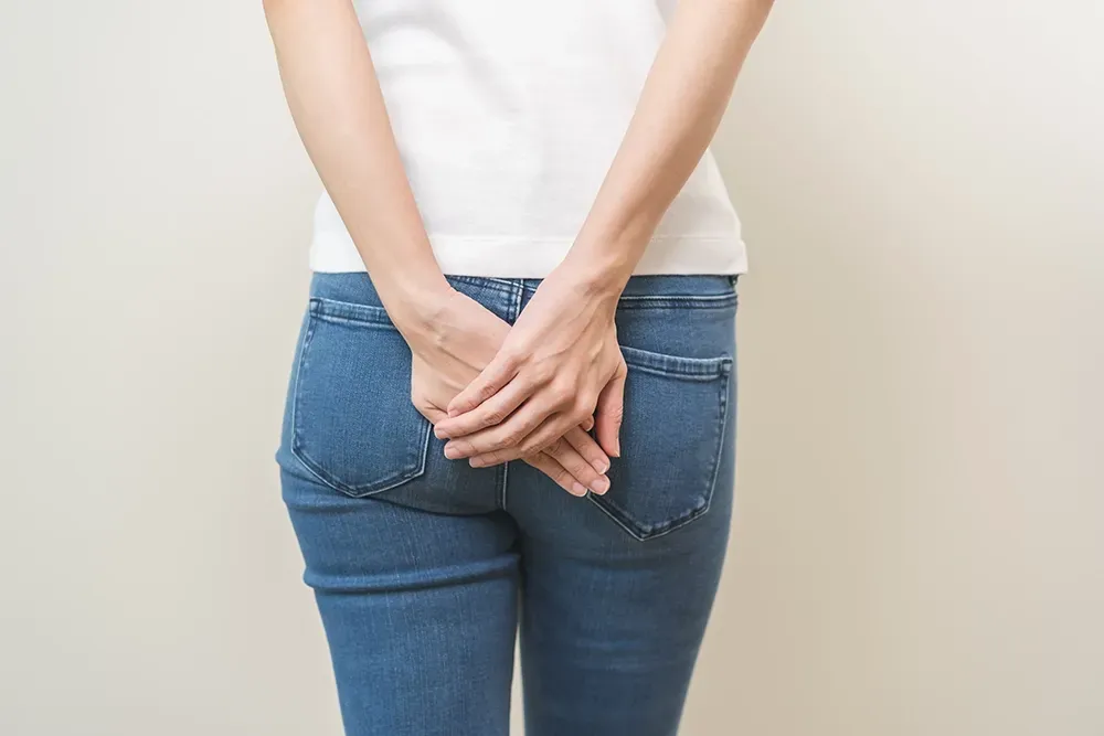 Person experiencing discomfort linked to haemorrhoids