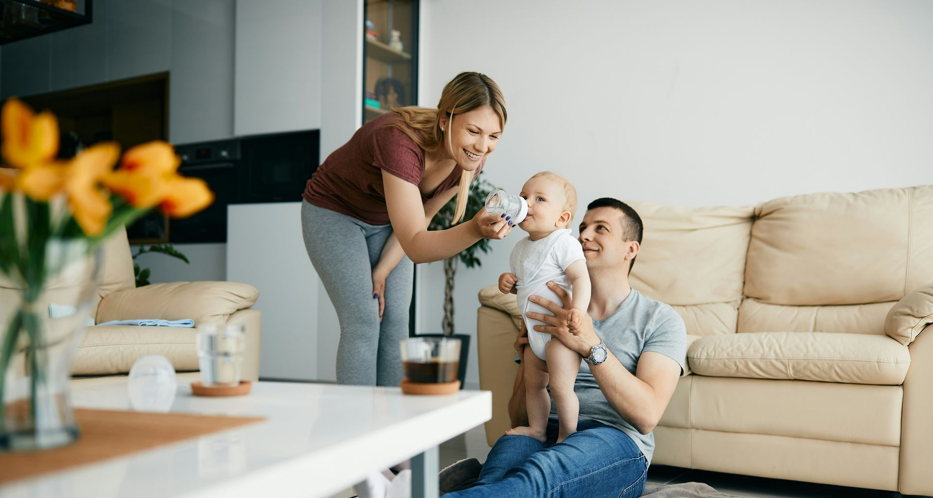 Patio with seating under a slatted pergola, overlooking a grassy backyard.